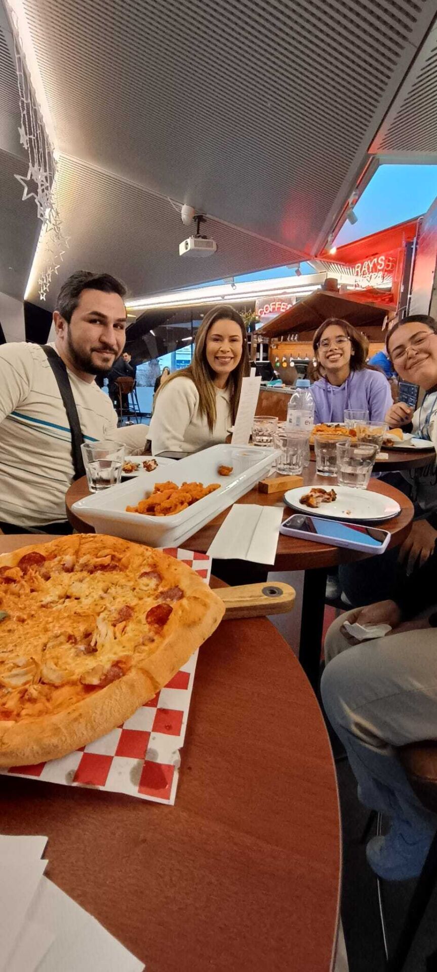 English Language students eating pizza